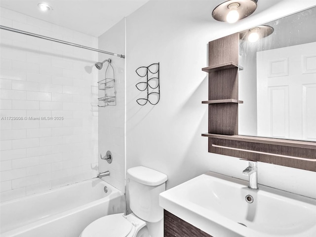 full bathroom featuring tiled shower / bath, vanity, and toilet