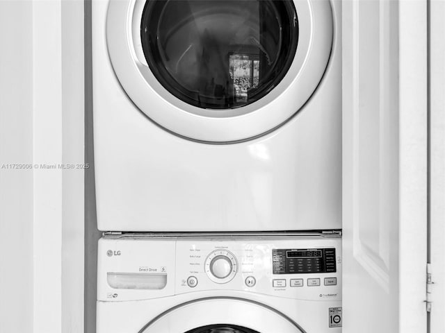 laundry room with stacked washing maching and dryer