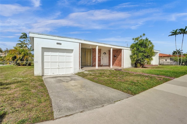 ranch-style home featuring a garage and a front yard