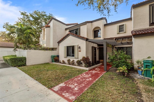 mediterranean / spanish house featuring a front lawn