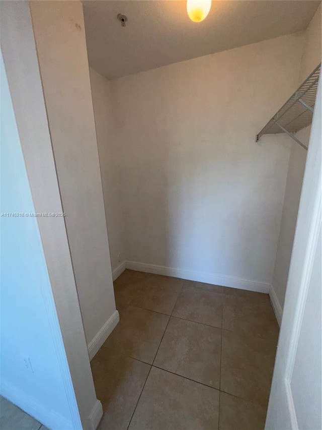 walk in closet with tile patterned floors