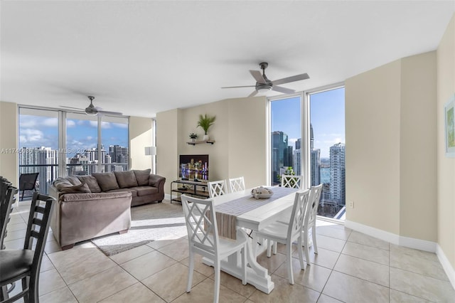 dining room with light tile patterned flooring, a healthy amount of sunlight, and expansive windows