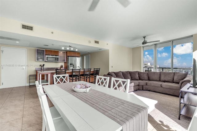 dining room featuring light tile patterned floors and ceiling fan