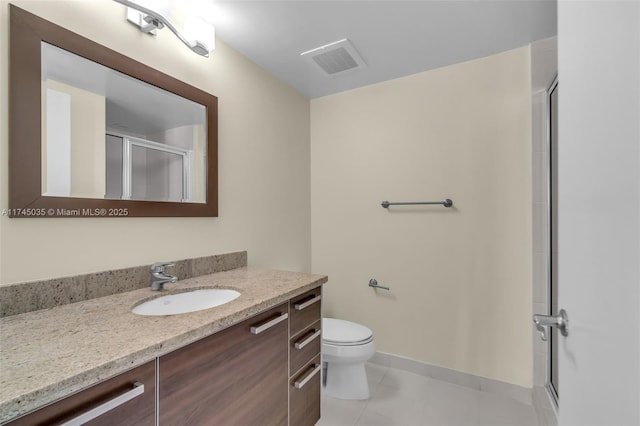 bathroom featuring toilet, tile patterned floors, vanity, and walk in shower