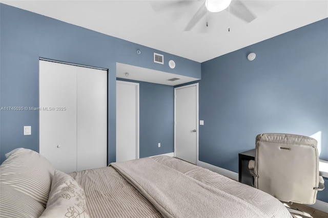 bedroom with ceiling fan and a closet