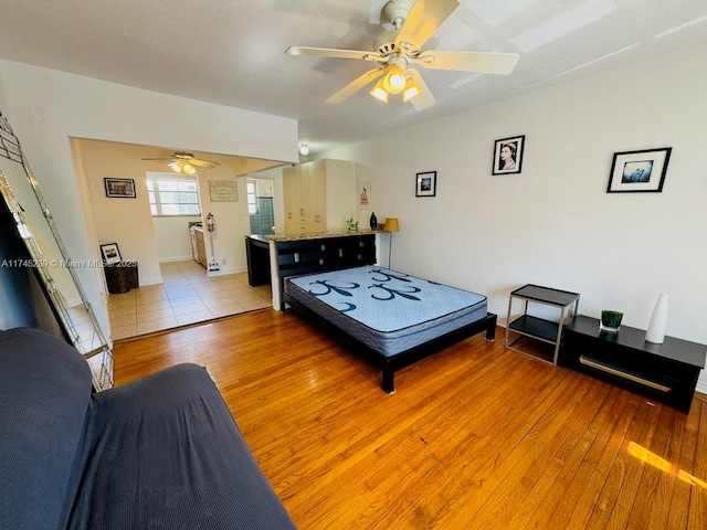 bedroom with ceiling fan and light hardwood / wood-style flooring