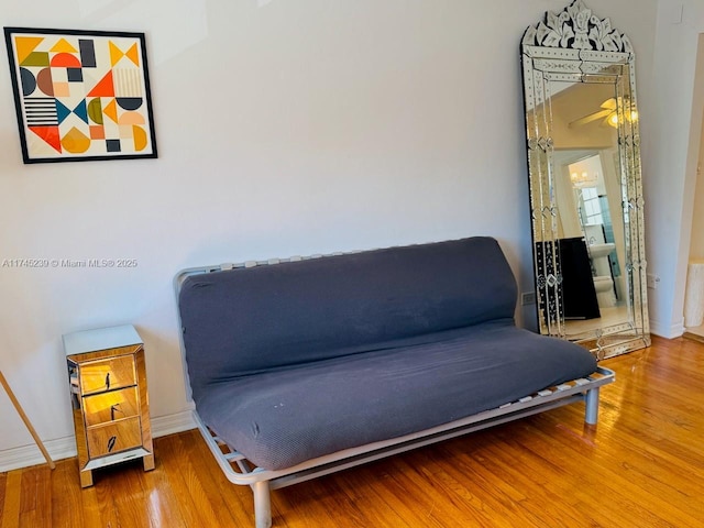 sitting room with wood-type flooring