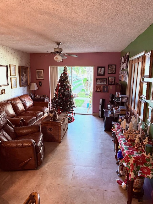 living room featuring ceiling fan and a textured ceiling