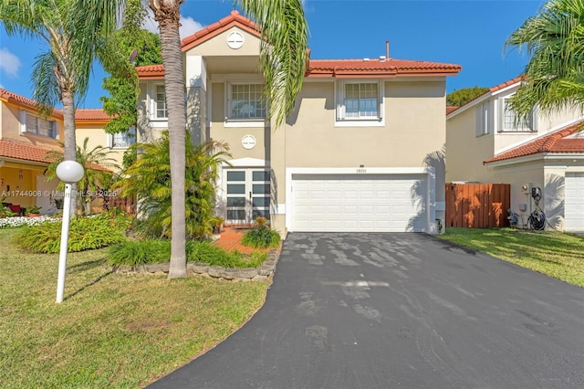 view of front of house with a garage and a front yard