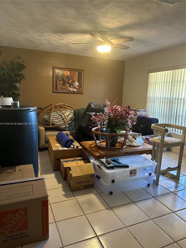 living room with ceiling fan and light tile patterned floors