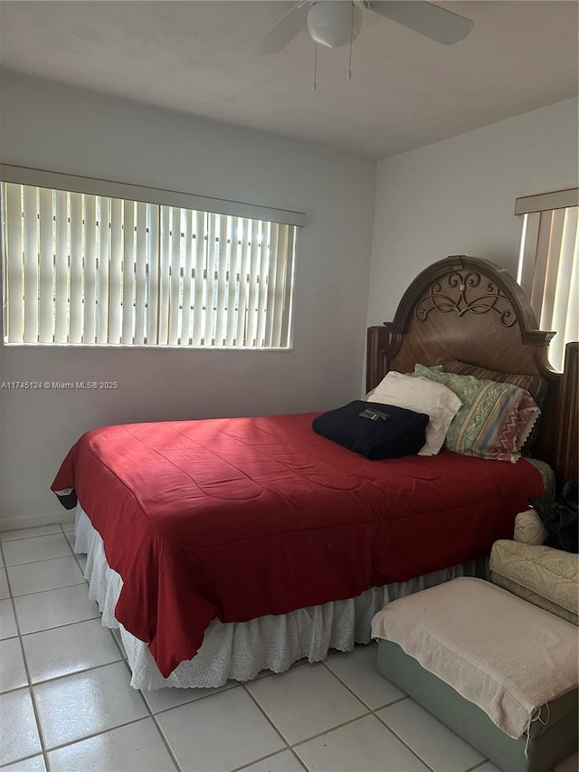 tiled bedroom featuring ceiling fan