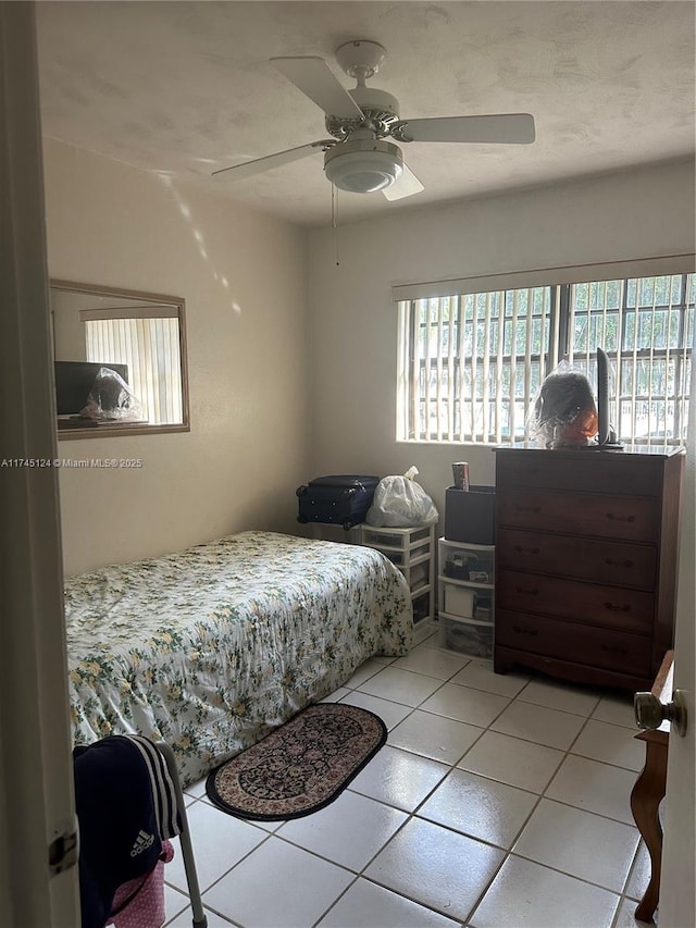 bedroom with light tile patterned floors and ceiling fan