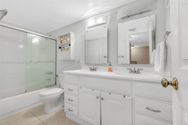 full bathroom featuring tile patterned flooring, vanity, shower / bath combination with glass door, and toilet