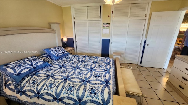 bedroom with light tile patterned floors and ornamental molding