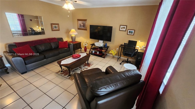 living room with baseboards, ornamental molding, ceiling fan, and light tile patterned flooring