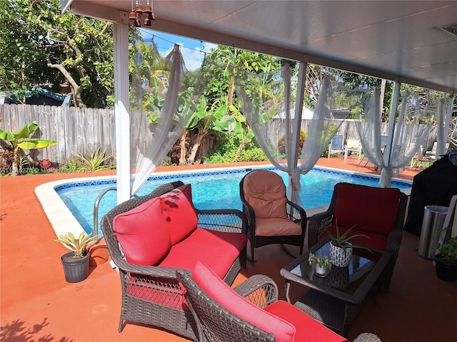 view of swimming pool featuring an outdoor living space and a patio area