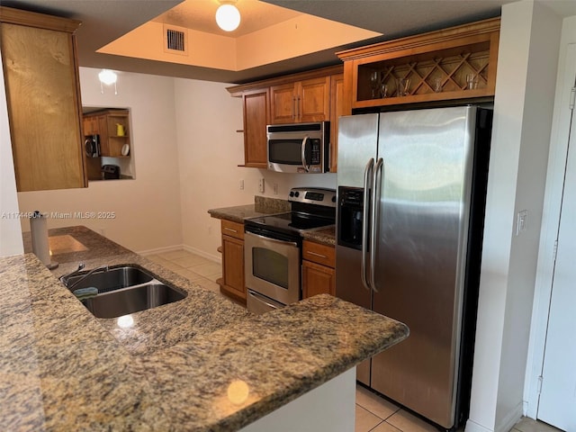 3530 SW 22nd St Unit 706, Miami, FL 33145 - kitchen with light tile patterned floors, visible vents, appliances with stainless steel finishes, brown cabinets, and open shelves