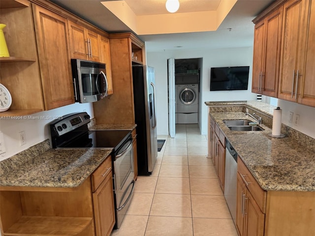 3530 SW 22nd St Unit 706, Miami, FL 33145 - kitchen featuring open shelves, a sink, washer / dryer, and stainless steel appliances