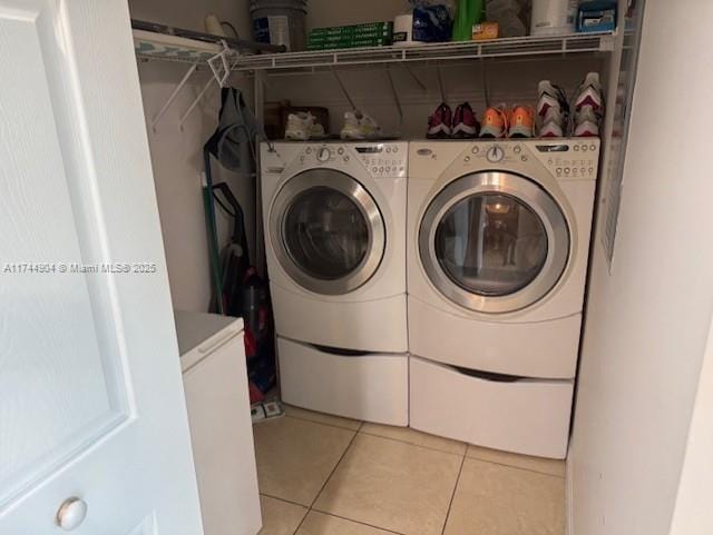 3530 SW 22nd St Unit 706, Miami, FL 33145 - clothes washing area featuring laundry area, light tile patterned floors, and washer and clothes dryer