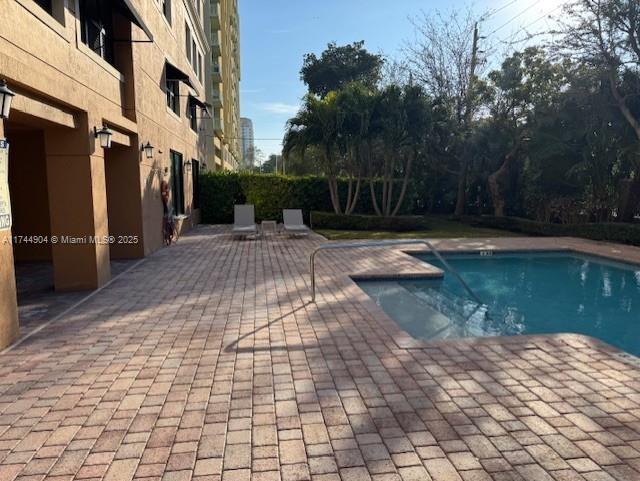3530 SW 22nd St Unit 706, Miami, FL 33145 - view of swimming pool with a fenced in pool and a patio