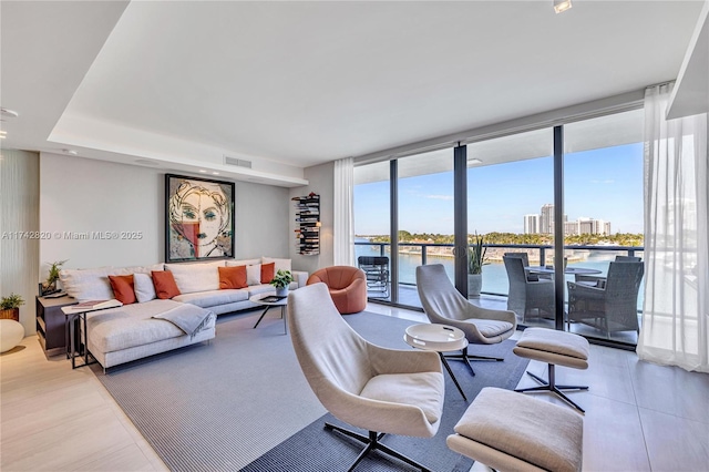 living room with expansive windows and visible vents