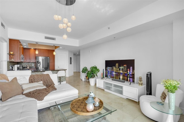 living room featuring a notable chandelier