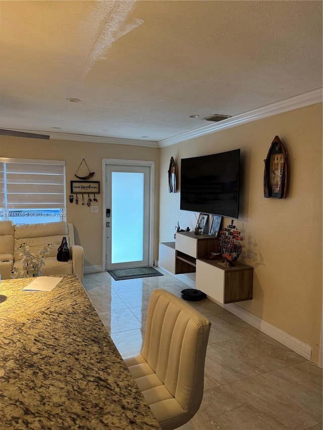 2770 NW 164th Ter, Miami Gardens, FL 33054 - living room featuring visible vents, baseboards, a textured ceiling, and crown molding