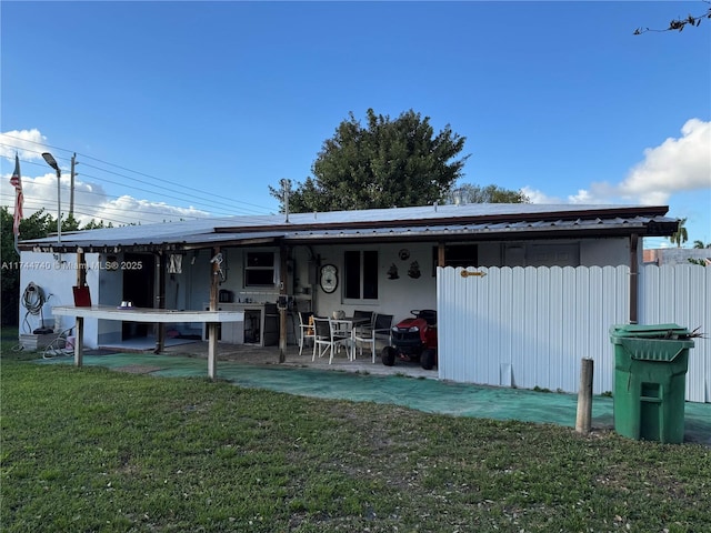 2770 NW 164th Ter, Miami Gardens, FL 33054 - back of property with a patio and a lawn