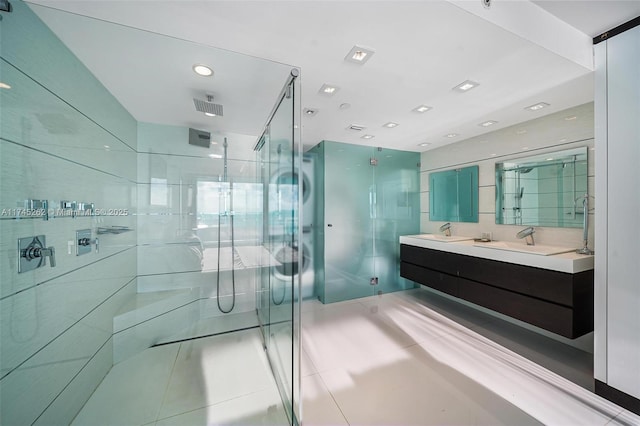 bathroom with vanity, tile walls, tile patterned floors, and walk in shower