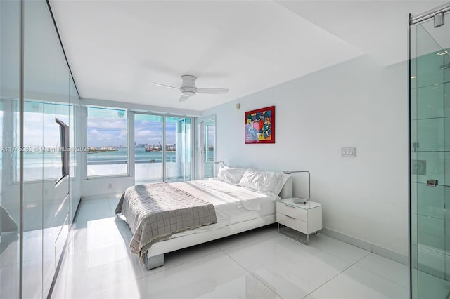 tiled bedroom with a water view and ceiling fan