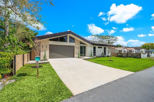 view of front of property with a garage and a front yard