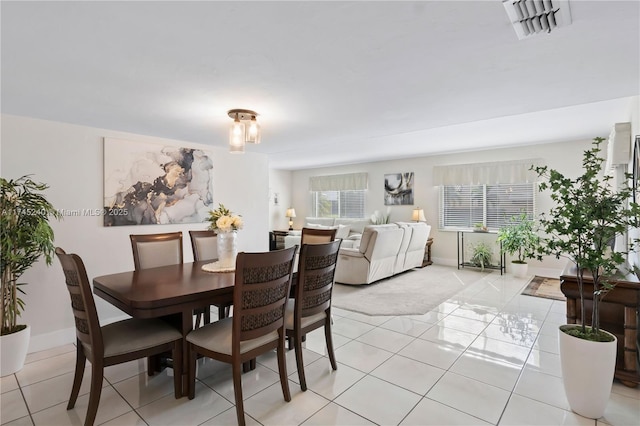 dining space featuring light tile patterned floors