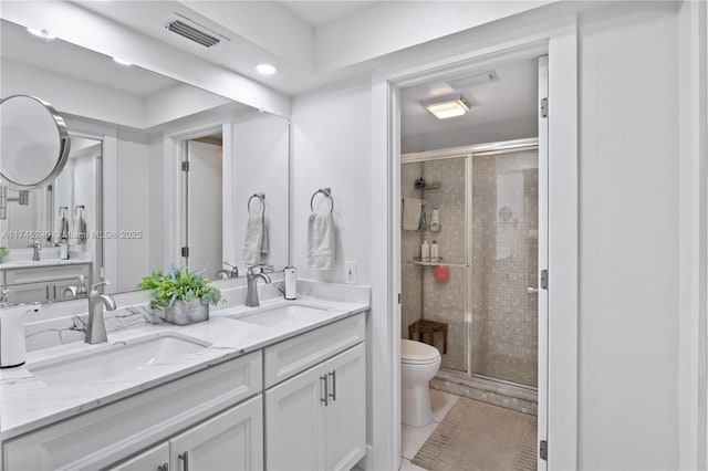 bathroom featuring vanity, an enclosed shower, and toilet