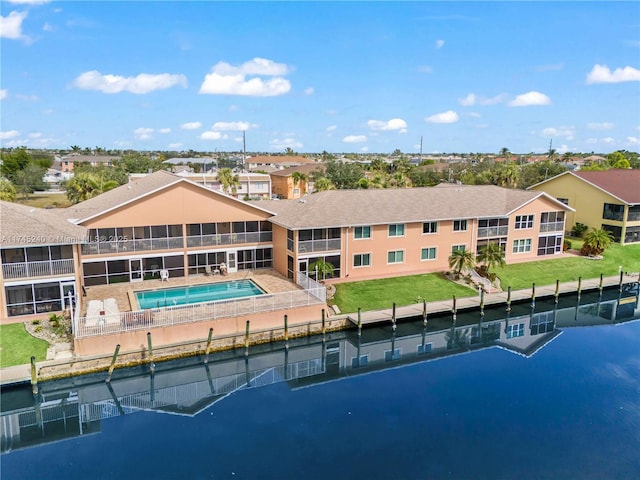 back of house with a community pool