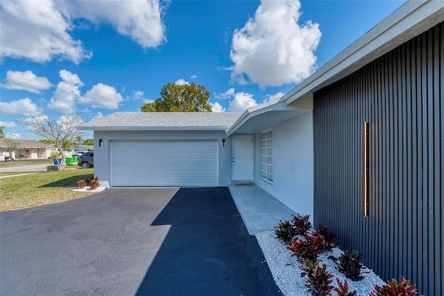 view of side of home featuring a garage