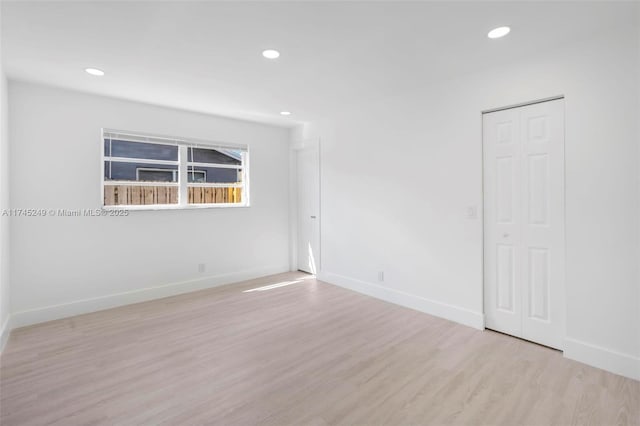 spare room with light hardwood / wood-style floors