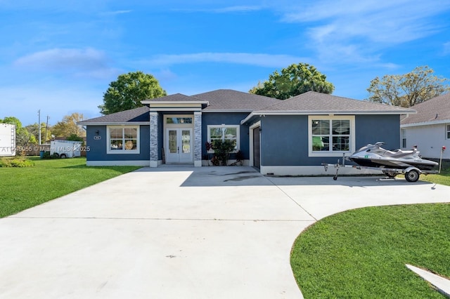 view of front of home with a front lawn and french doors