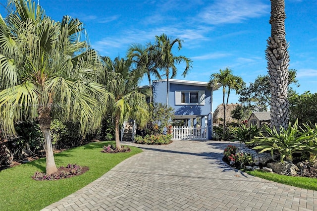 beach home with a front lawn