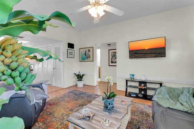 living room with ceiling fan and light wood-type flooring