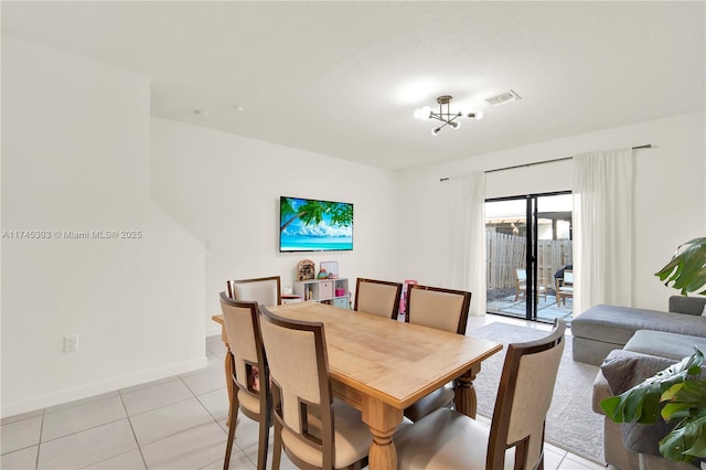 dining room with light tile patterned floors, baseboards, and visible vents