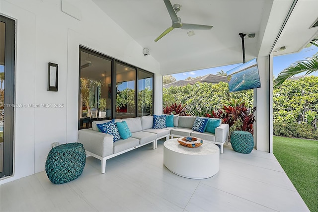 view of patio with an outdoor living space with a fire pit and ceiling fan