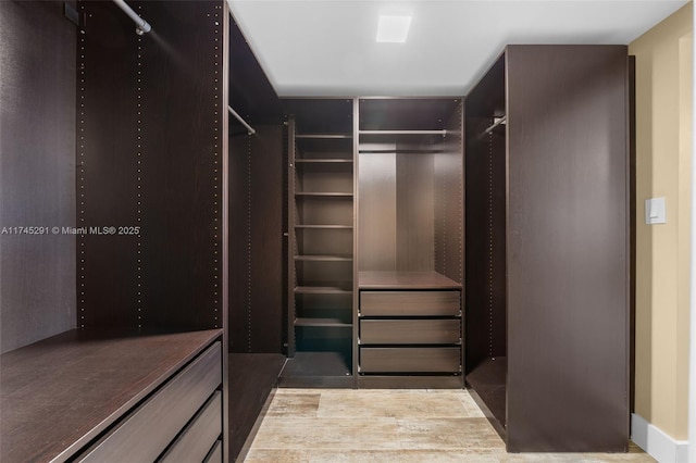 spacious closet with light hardwood / wood-style floors