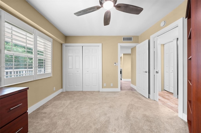 unfurnished bedroom with light carpet and ceiling fan