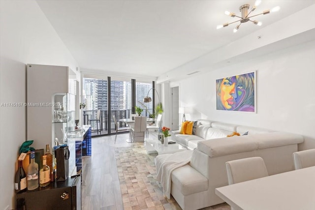 living room featuring an inviting chandelier and floor to ceiling windows