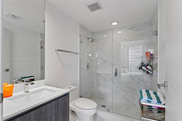 bathroom featuring vanity, toilet, and a shower with shower door