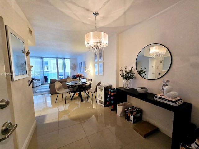 dining room featuring visible vents, baseboards, tile patterned floors, expansive windows, and an inviting chandelier