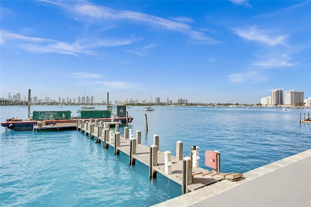 dock area featuring a city view and a water view