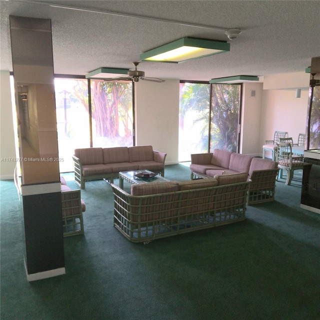 living room with ceiling fan, carpet, and a wall of windows