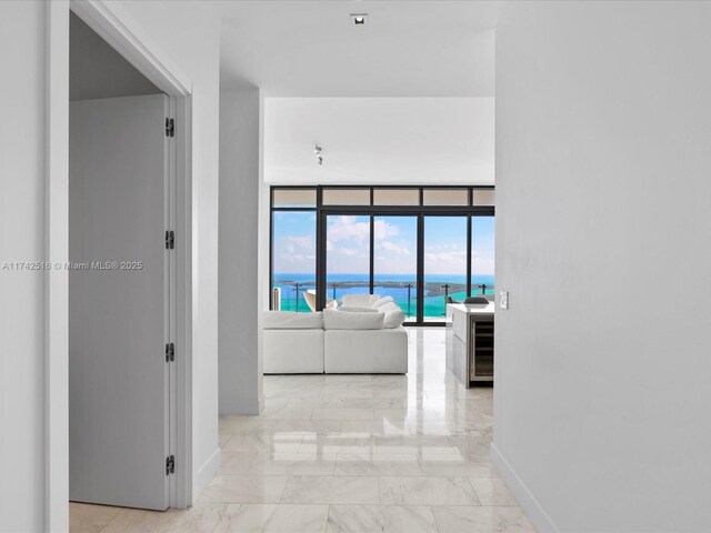 1451 Brickell Ave Unit 5101, Miami, FL 33131 - hallway featuring marble finish floors, beverage cooler, a water view, and floor to ceiling windows
