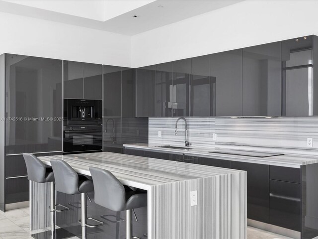 1451 Brickell Ave Unit 5101, Miami, FL 33131 - kitchen featuring modern cabinets, gray cabinets, a breakfast bar, and decorative backsplash